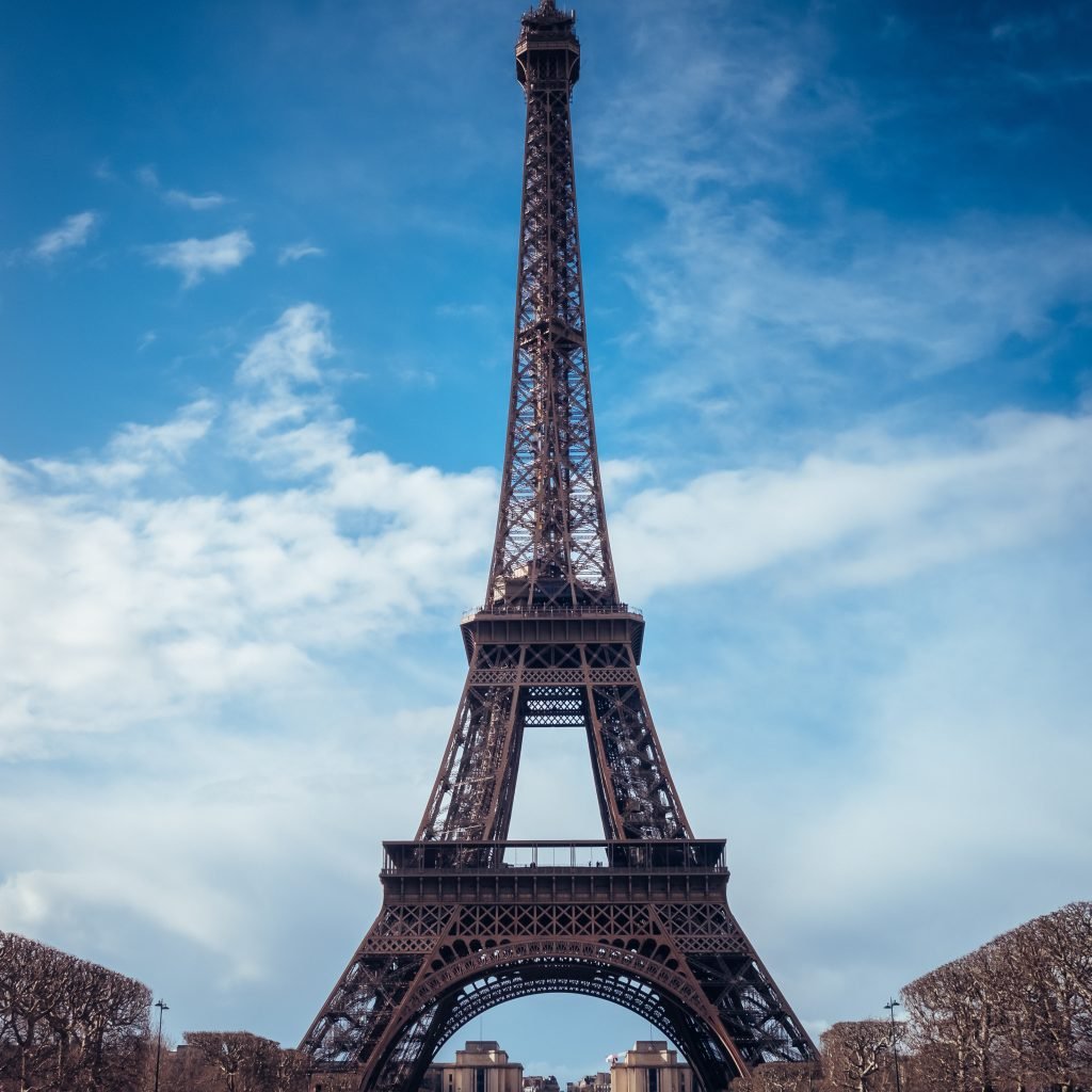 A beautiful vertical shot of the Eiffel Tower on a bright blue sky background